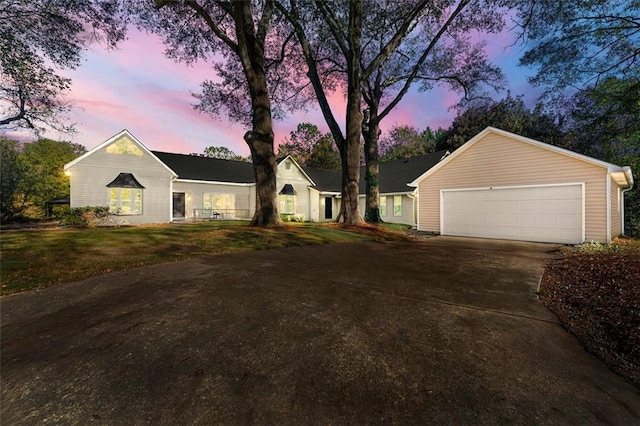 ranch-style house featuring concrete driveway and a garage