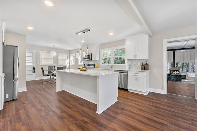 kitchen featuring white cabinetry, stainless steel appliances, and light countertops