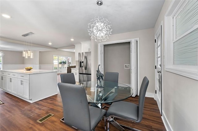 dining space featuring dark wood-type flooring, a chandelier, recessed lighting, and visible vents