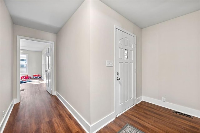 entryway with visible vents, wood finished floors, and baseboards