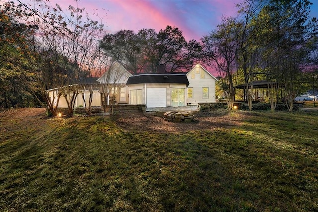 rear view of property with a yard