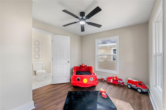 recreation room with baseboards, wood finished floors, and ceiling fan