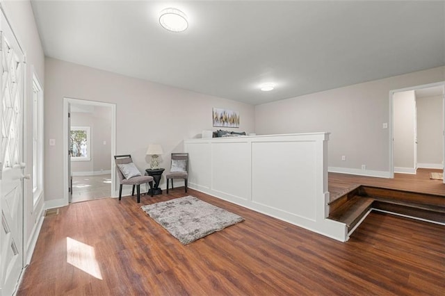 sitting room featuring baseboards and wood finished floors
