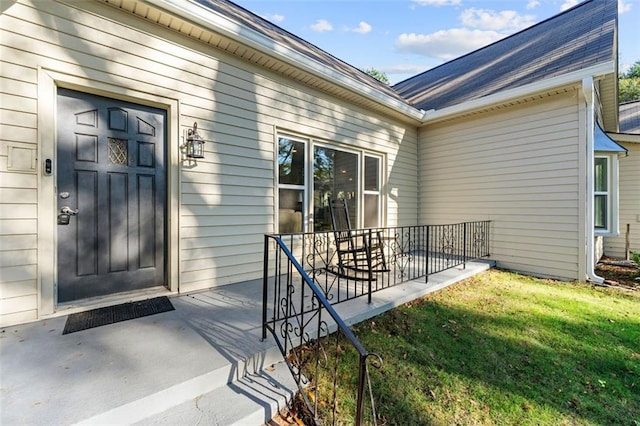 property entrance featuring a lawn