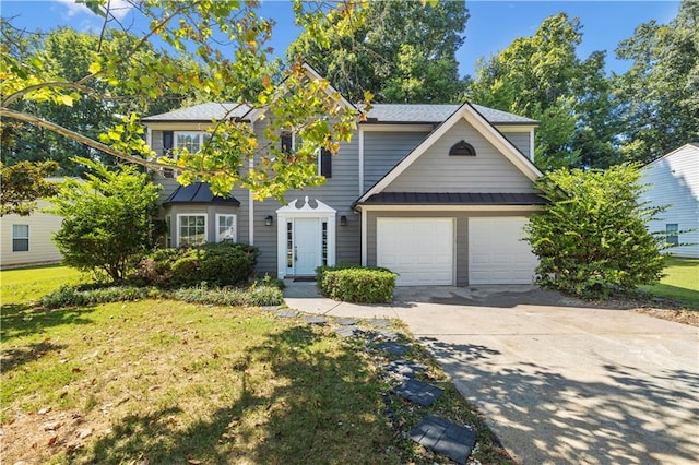 view of front of house with a garage and a front yard