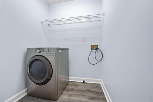 laundry room featuring washer / clothes dryer and hardwood / wood-style flooring