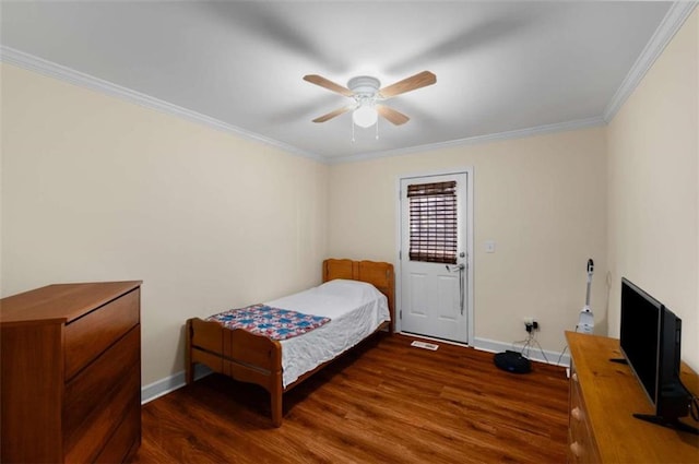 bedroom with a ceiling fan, crown molding, baseboards, and wood finished floors