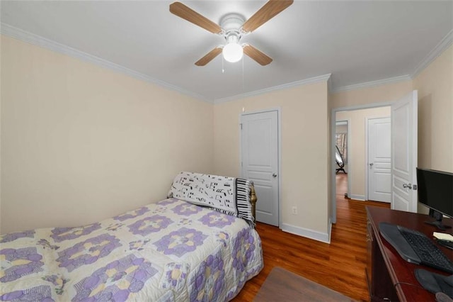 bedroom with ornamental molding, ceiling fan, baseboards, and wood finished floors