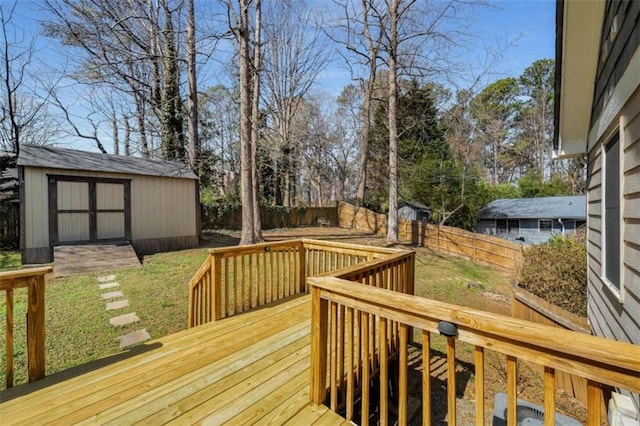 deck featuring a shed, an outdoor structure, and a fenced backyard