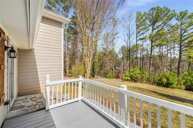 wooden deck featuring a yard