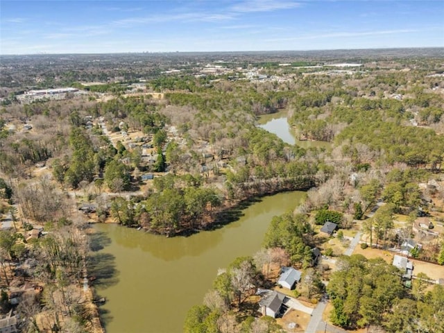 drone / aerial view featuring a forest view and a water view