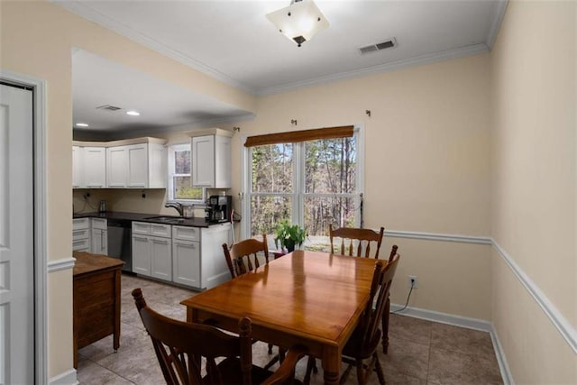 dining space with ornamental molding, visible vents, baseboards, and light tile patterned floors