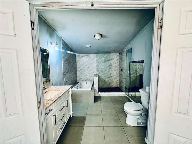 full bathroom featuring toilet, vanity, tile patterned floors, and separate shower and tub