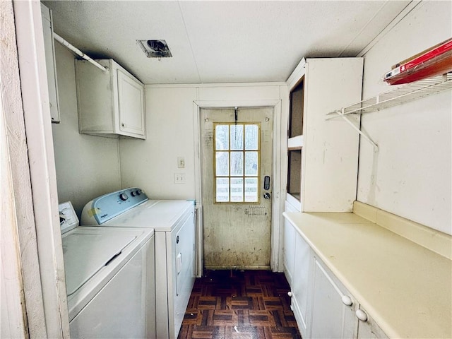 laundry area featuring independent washer and dryer, cabinets, and dark parquet floors