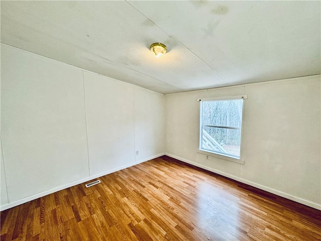 unfurnished room featuring hardwood / wood-style floors