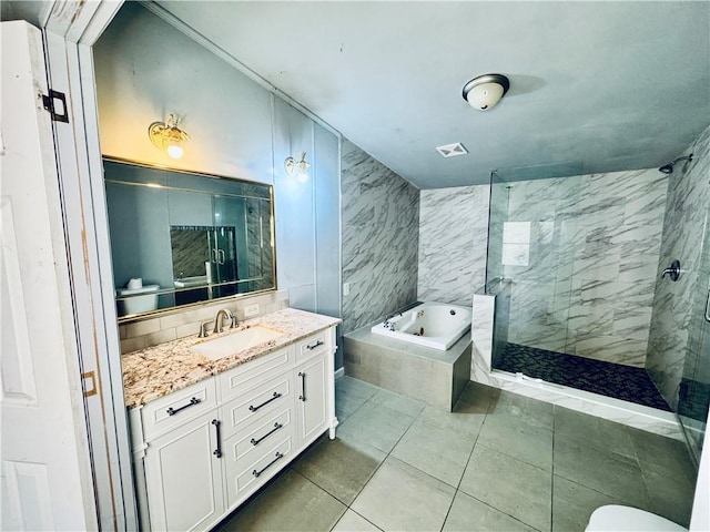 bathroom featuring shower with separate bathtub, vanity, and tile patterned floors