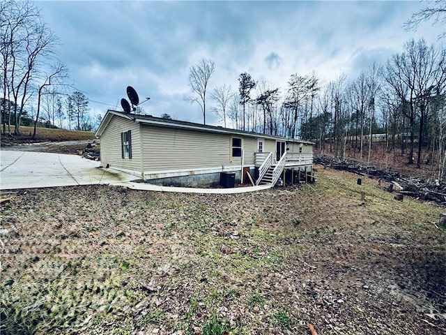 rear view of house with a deck and a patio area