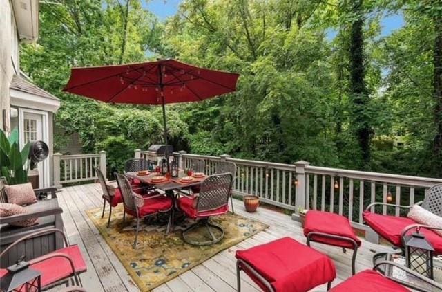 deck with outdoor dining area