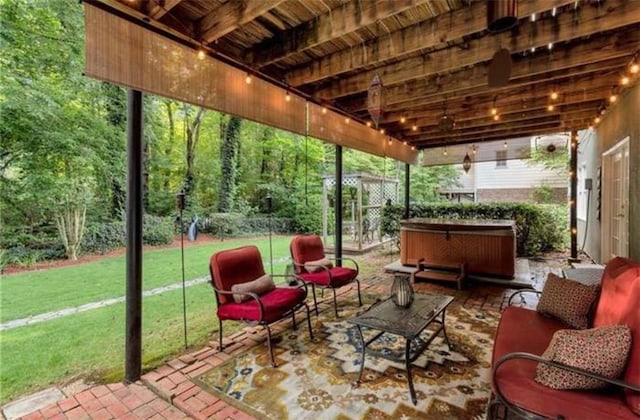 view of patio / terrace with a view of trees, outdoor lounge area, and a hot tub
