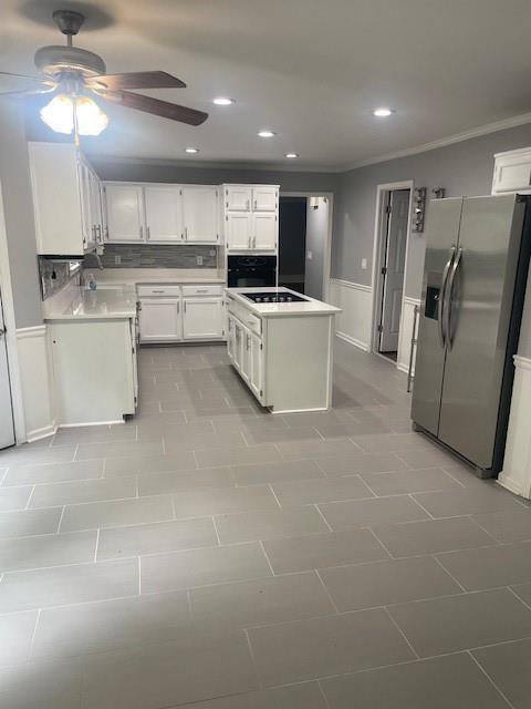 kitchen featuring ceiling fan, black electric cooktop, stainless steel fridge with ice dispenser, white cabinets, and recessed lighting