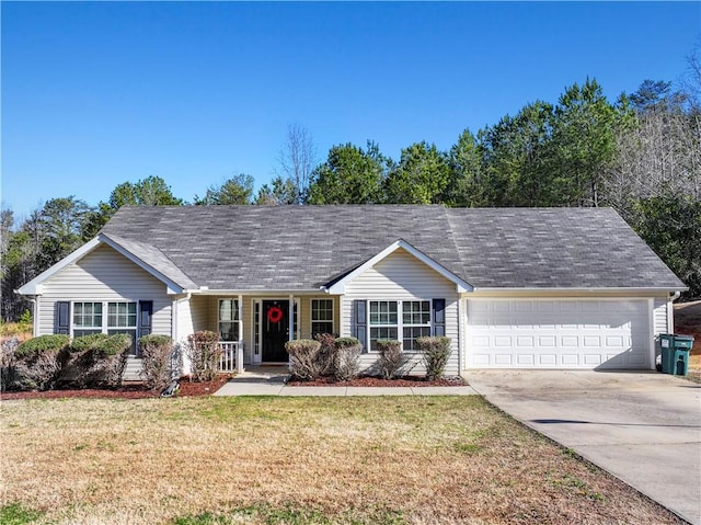 ranch-style home featuring an attached garage, concrete driveway, and a front yard