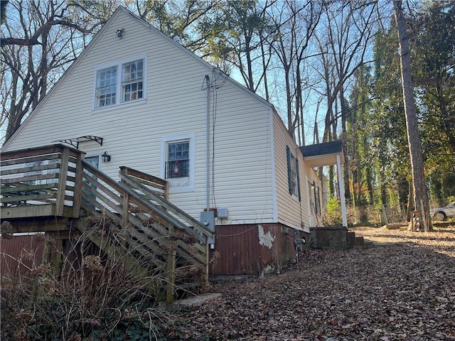 view of side of home with a wooden deck