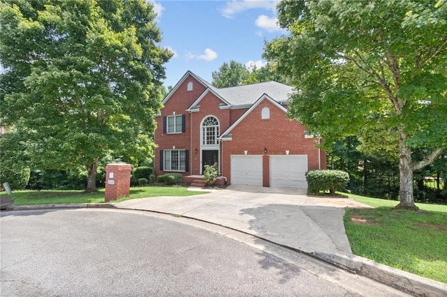 view of front facade featuring brick siding, a front yard, and driveway