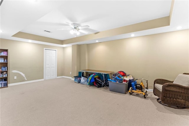 rec room featuring a raised ceiling, baseboards, visible vents, and ceiling fan