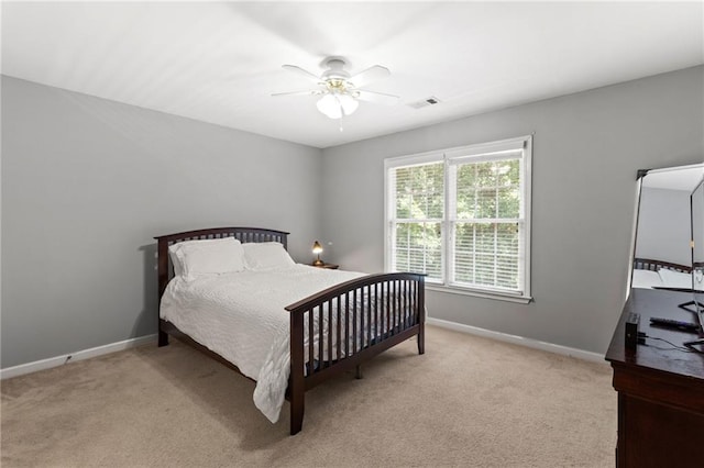 bedroom with visible vents, baseboards, carpet, and a ceiling fan