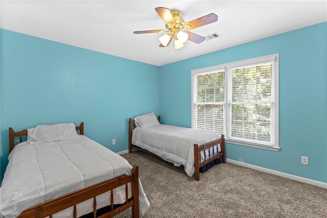 bedroom featuring a ceiling fan, baseboards, visible vents, and carpet floors