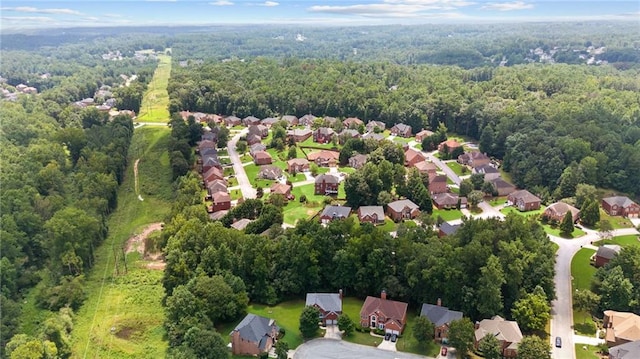 drone / aerial view with a residential view and a forest view