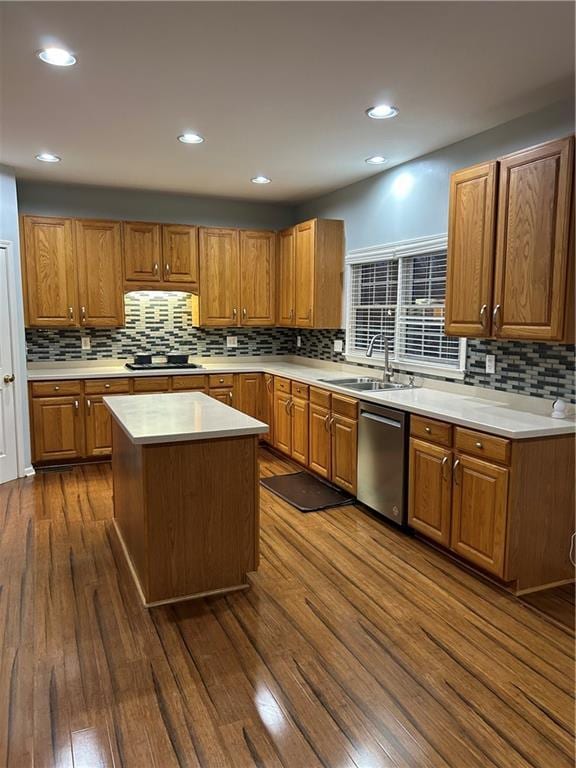 kitchen featuring dishwasher, dark wood-style floors, brown cabinets, and a sink