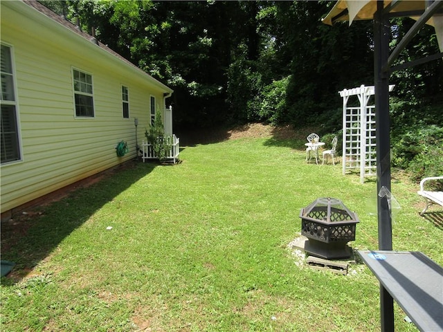 274 Griffith St, Winder, GA 30680 - view of grassy yard featuring an outdoor fire pit