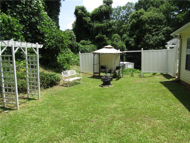 274 Griffith St, Winder, GA 30680 - view of green lawn featuring a fire pit and an outbuilding