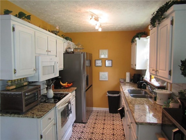 274 Griffith St, Winder, GA 30680 - kitchen featuring a sink, white appliances, a textured ceiling, baseboards, and decorative backsplash