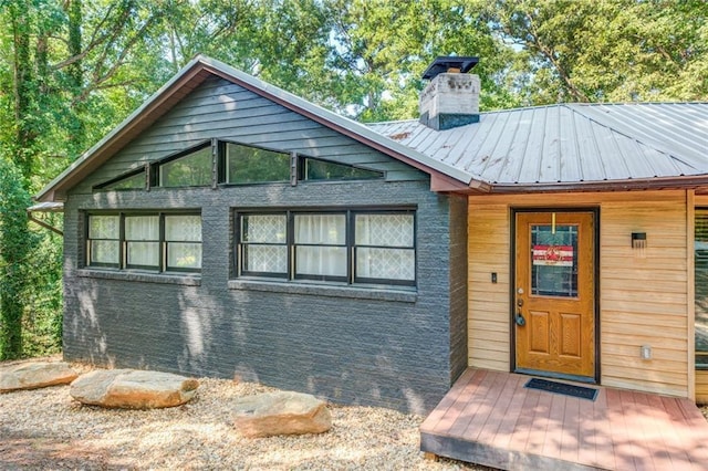 1019 Whippoorwill Rd, Monticello, GA 31064 - view of front of property featuring a chimney, a metal roof, and a standing seam roof