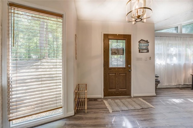 1019 Whippoorwill Rd, Monticello, GA 31064 - entrance foyer with a chandelier, plenty of natural light, and wood finished floors
