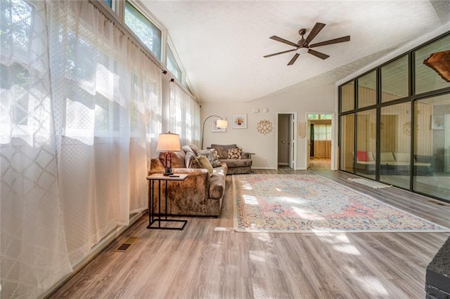 1019 Whippoorwill Rd, Monticello, GA 31064 - living area with ceiling fan, wood finished floors, and vaulted ceiling