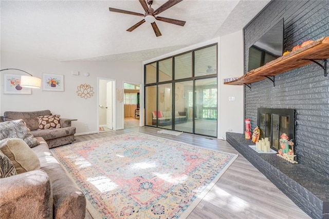 1019 Whippoorwill Rd, Monticello, GA 31064 - living room with a ceiling fan, wood finished floors, and a brick fireplace