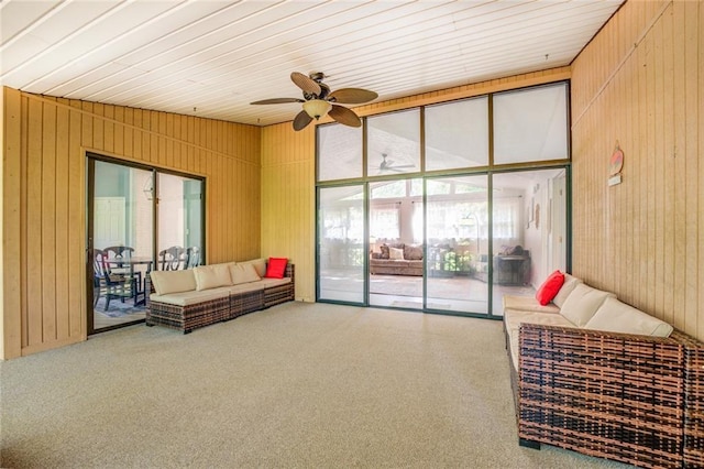 1019 Whippoorwill Rd, Monticello, GA 31064 - carpeted living room with a ceiling fan and wood walls