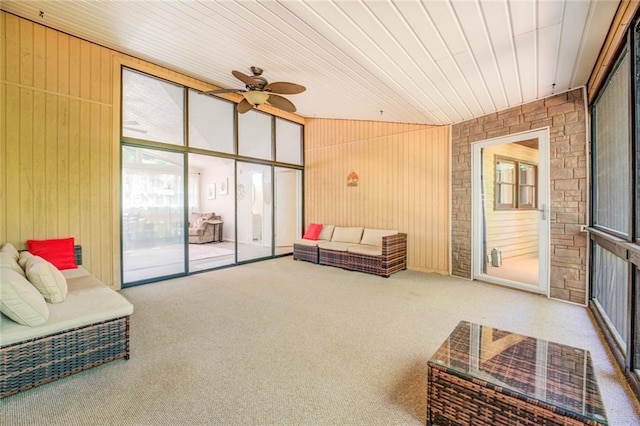 1019 Whippoorwill Rd, Monticello, GA 31064 - carpeted living area with wooden walls, a ceiling fan, and vaulted ceiling