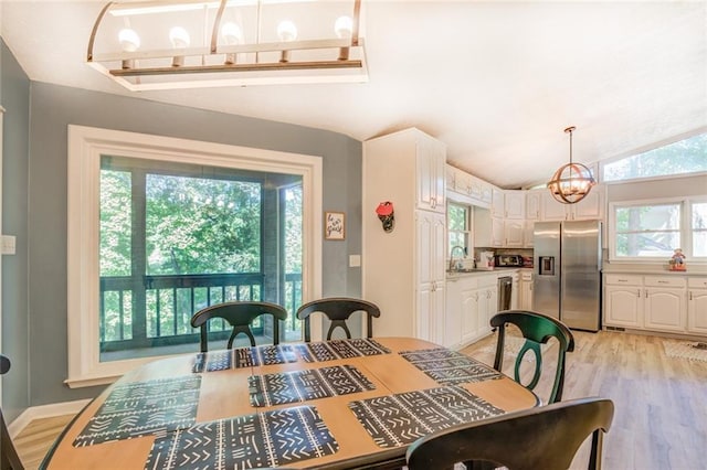 1019 Whippoorwill Rd, Monticello, GA 31064 - dining area with plenty of natural light, a chandelier, light wood-style flooring, and vaulted ceiling