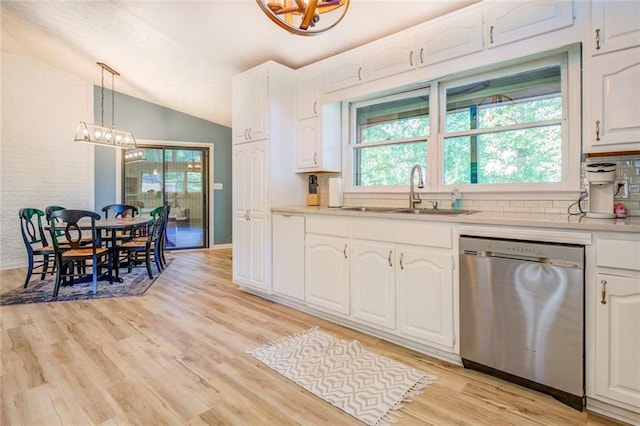 1019 Whippoorwill Rd, Monticello, GA 31064 - kitchen with stainless steel dishwasher, vaulted ceiling, white cabinets, a chandelier, and light countertops