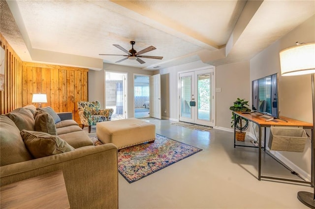 1019 Whippoorwill Rd, Monticello, GA 31064 - living area featuring finished concrete flooring, a ceiling fan, and wooden walls