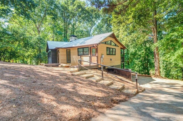 1019 Whippoorwill Rd, Monticello, GA 31064 - rustic home featuring a metal roof and a chimney