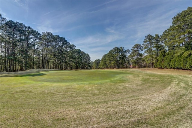 1019 Whippoorwill Rd, Monticello, GA 31064 - view of community featuring view of golf course, a yard, and view of wooded area