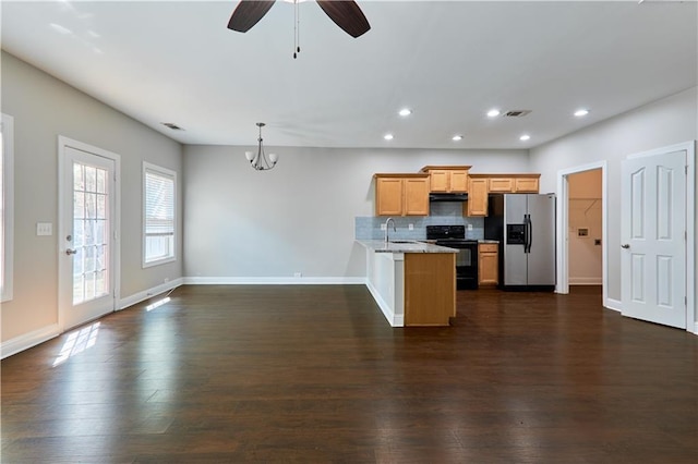 kitchen featuring black range with electric stovetop, backsplash, stainless steel refrigerator with ice dispenser, decorative light fixtures, and kitchen peninsula