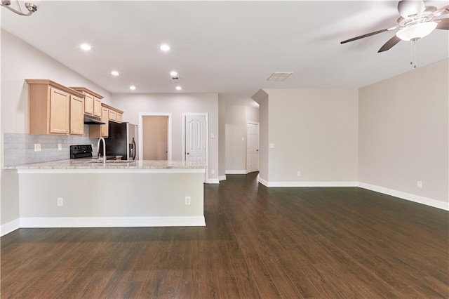 kitchen featuring stainless steel fridge, backsplash, dark hardwood / wood-style flooring, and light brown cabinets