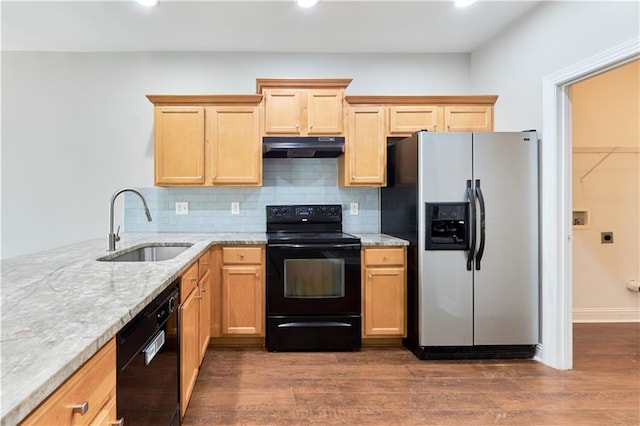 kitchen featuring sink, light stone counters, black appliances, dark hardwood / wood-style floors, and backsplash