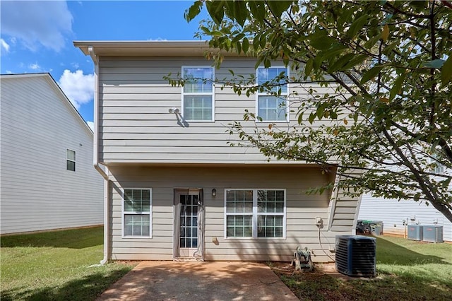 rear view of house with central AC unit, a yard, and a patio